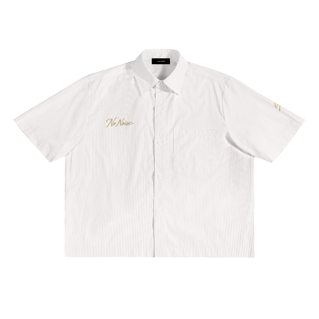 Quiet Conviction boxy shirt in Apricot White, front view, showing fine vertical stripes, short sleeves and gold-tone chest lettering.