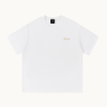 Essential Signature Tee in white, front view with small gold No Noise script at the left chest