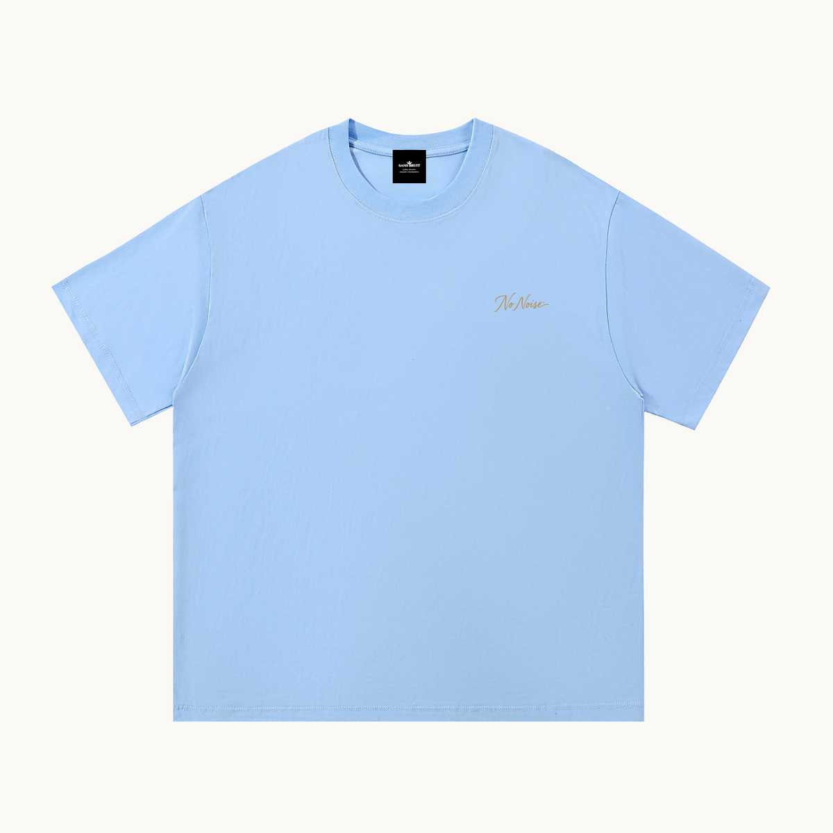 Essential Signature Tee in light blue, front view with small gold No Noise script at the left chest