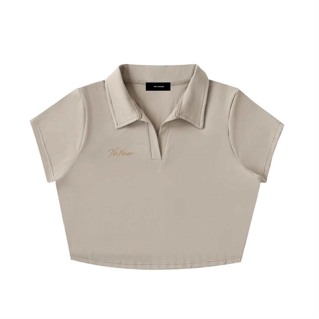 NO NOISE Silent Code Cropped Polo, beige, front view with a collar, short sleeves and gold chest script.