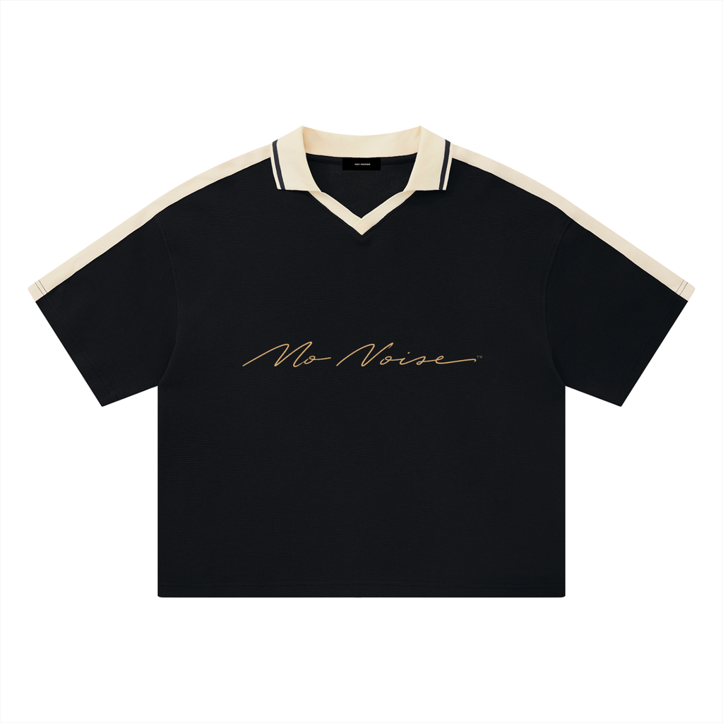 NO NOISE™ Chapter 001 Paris Unisex Color Block Polo Shirt — Black/Cream, front view, drop-shoulder silhouette
