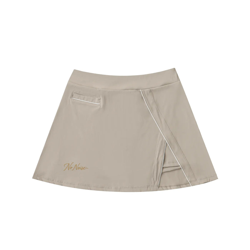 NO NOISE Silent Motion Skirt, beige, front view with asymmetric wrap panel and gold script.