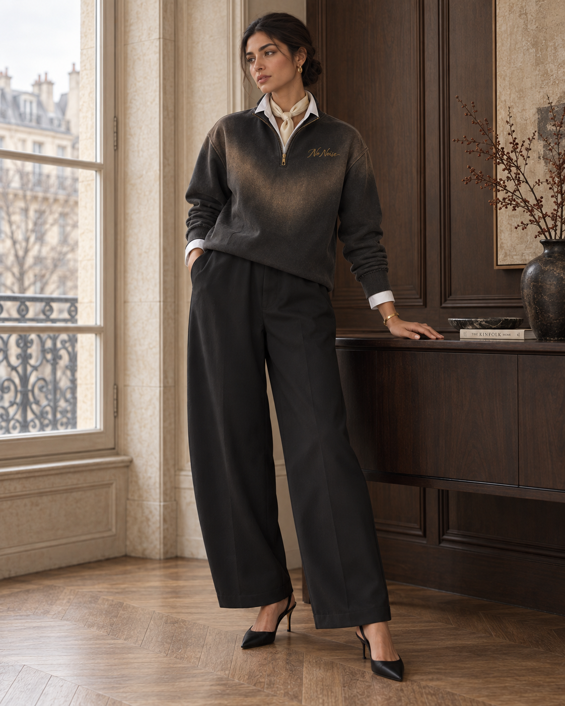 HER Quiet Layers look: approved model wearing washed-black quarter-zip over a white Signature Shirt with black Still Form trousers.