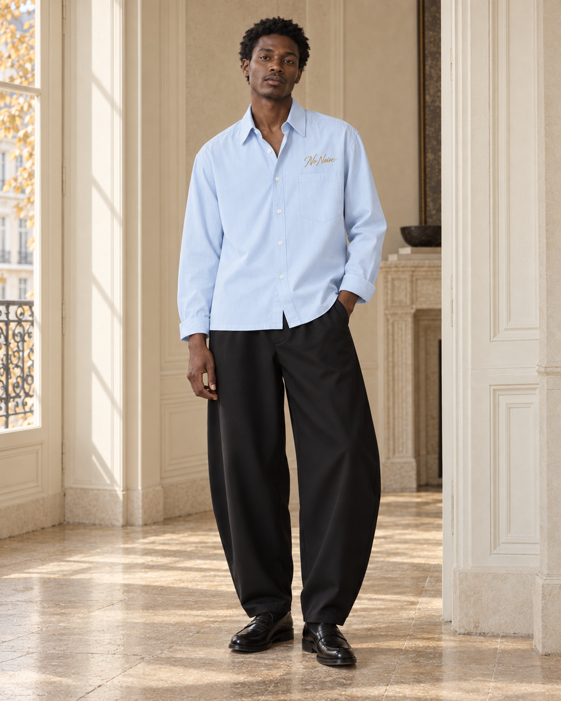HIM Morning Sky look: pale blue Signature Shirt with black Still Form barrel trousers and loafers.