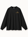 Quiet Signal long-sleeve T-shirt in Black, front view, showing the round neckline, drop shoulders and gold-tone Shh. / NO NOISE chest lettering.