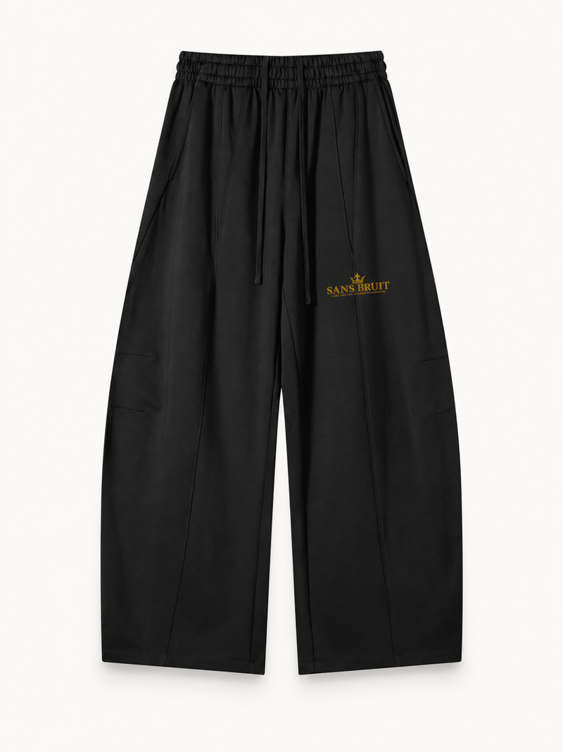 NO NOISE Quiet Standard Wide-Leg Sweatpant — Black, front view showing drawstring waist, wide legs and gold artwork.