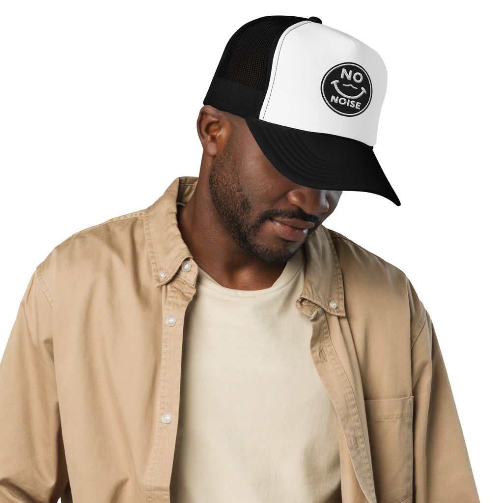 NO NOISE™ Quiet Signal foam trucker hat, alternate angled view showing the embroidered front badge.