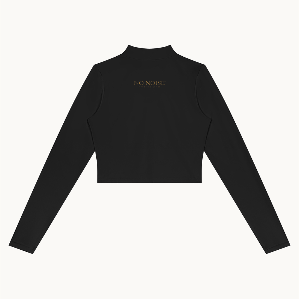 Form Cropped Jacket — Onyx, black, back view showing cropped hem and small gold lettering. On warm ivory.