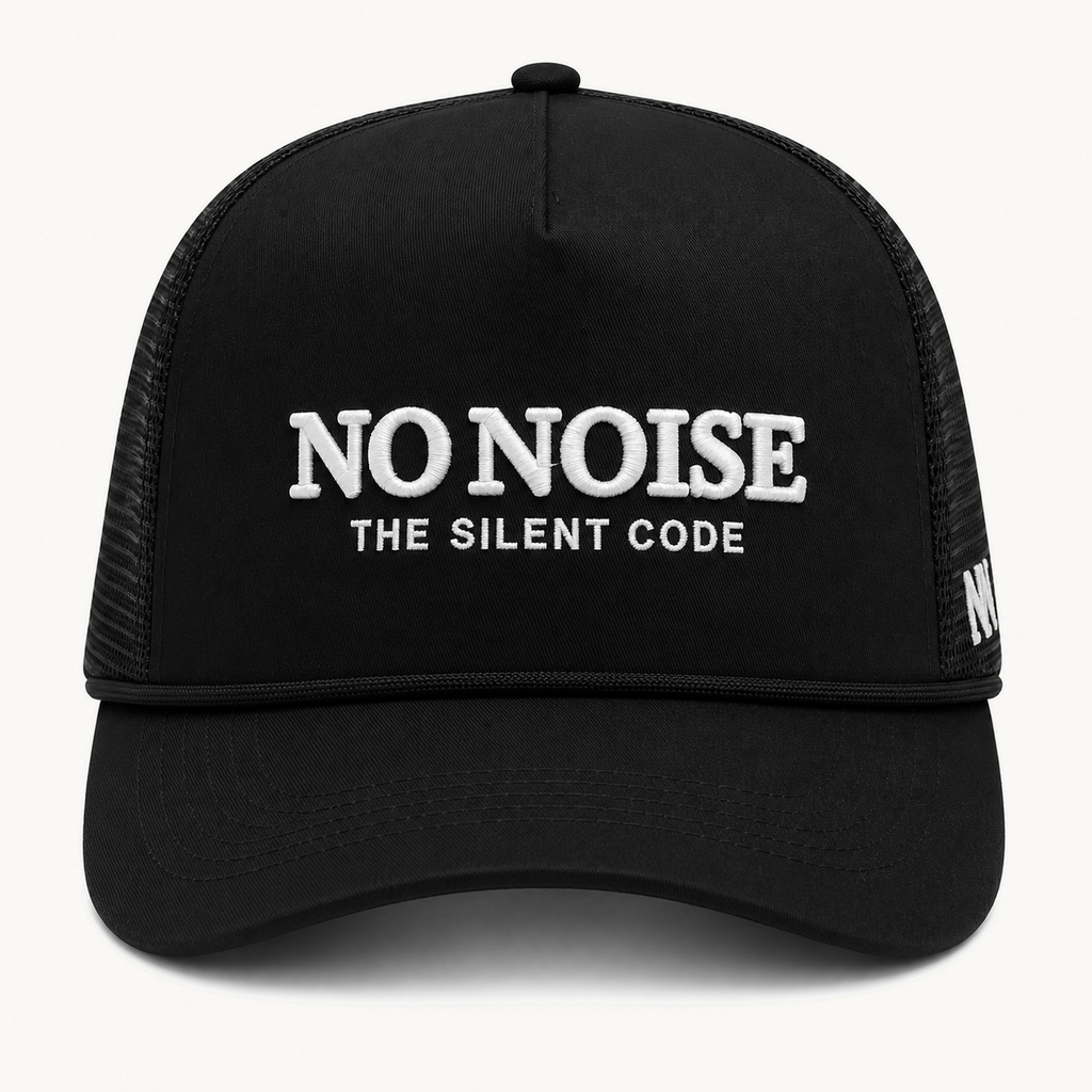 Shadow Code Trucker Hat — Black — product view on warm ivory.