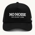 Shadow Code Trucker Hat — Black — product view on warm ivory.