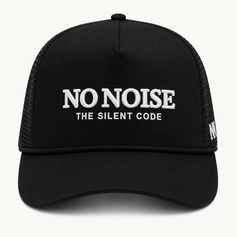 Shadow Code Trucker Hat — Black — product view on warm ivory.