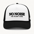 Light Code Trucker Hat — White/Black — product view on warm ivory.