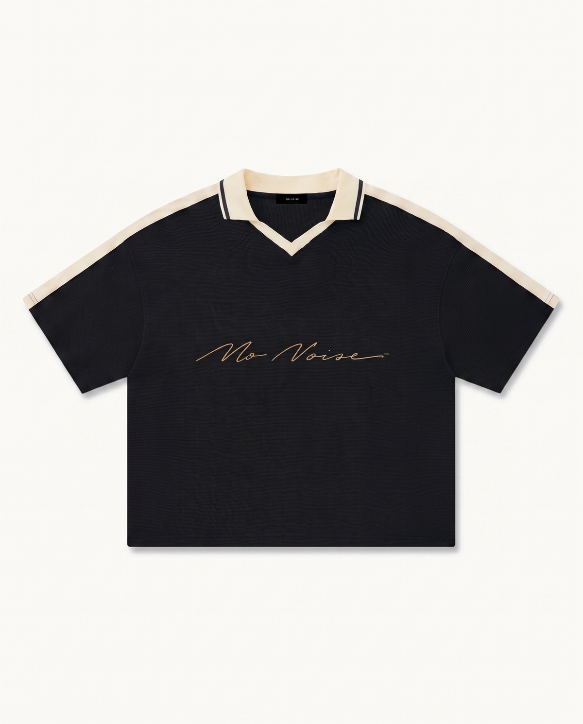 NO NOISE™ CHAPTER 001 PARIS UNISEX COLOR BLOCK POLO SHIRT — BLACK/CREAM — product view on warm ivory.