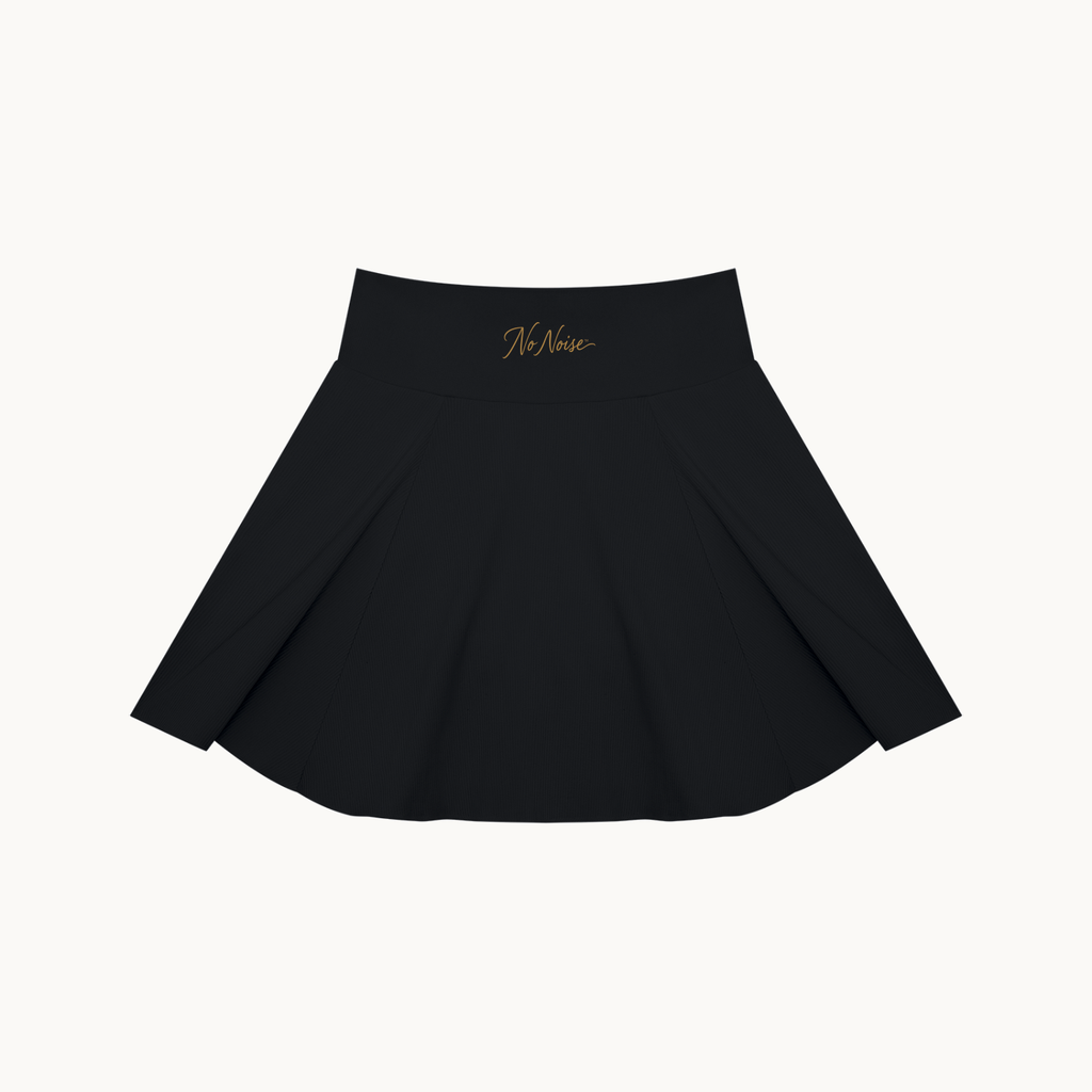 THE COURT SKIRT — BLACK — product view on warm ivory.