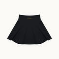 THE COURT SKIRT — BLACK — product view on warm ivory.