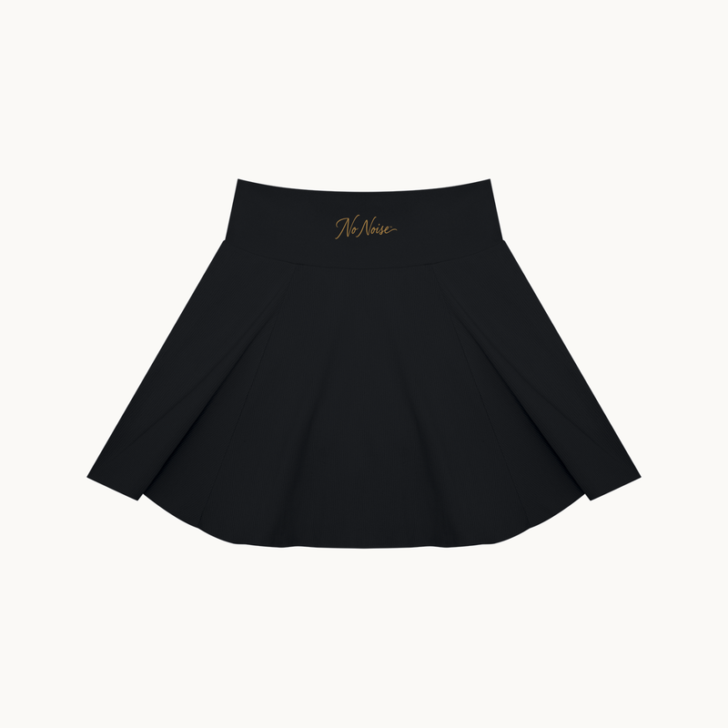 THE COURT SKIRT — BLACK — product view on warm ivory.