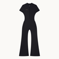 MOTION FLARE JUMPSUIT — product view on warm ivory.