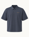 THE SIGNATURE DROP SHOULDER POLO — SLATE BLUE — product view on warm ivory.