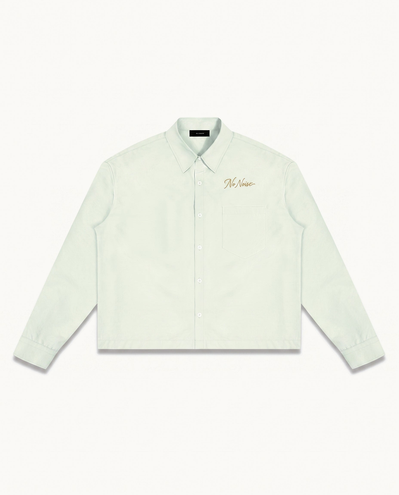 THE SIGNATURE SHIRT™ — LIGHT GREEN — product view on warm ivory.