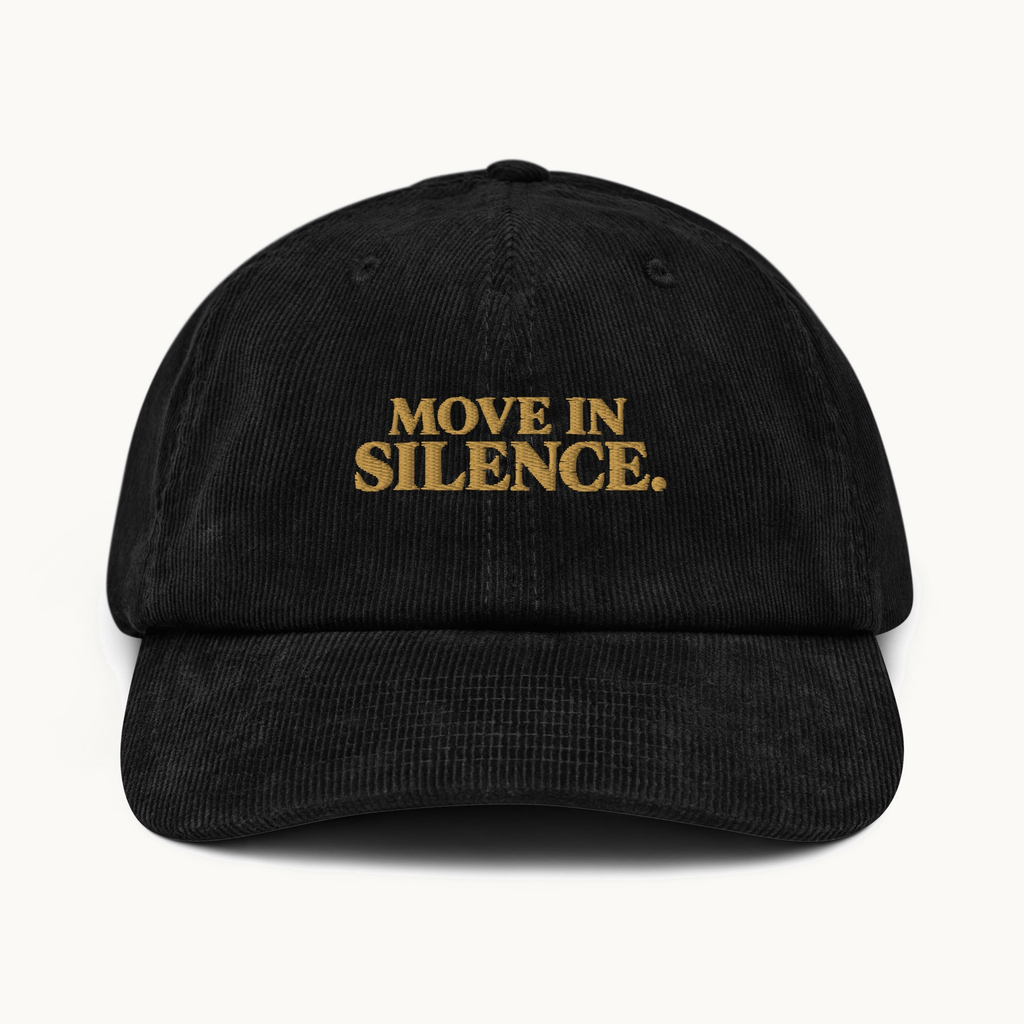 NO NOISE™ MOVE IN SILENCE CORDUROY CAP — BLACK — product view on warm ivory.