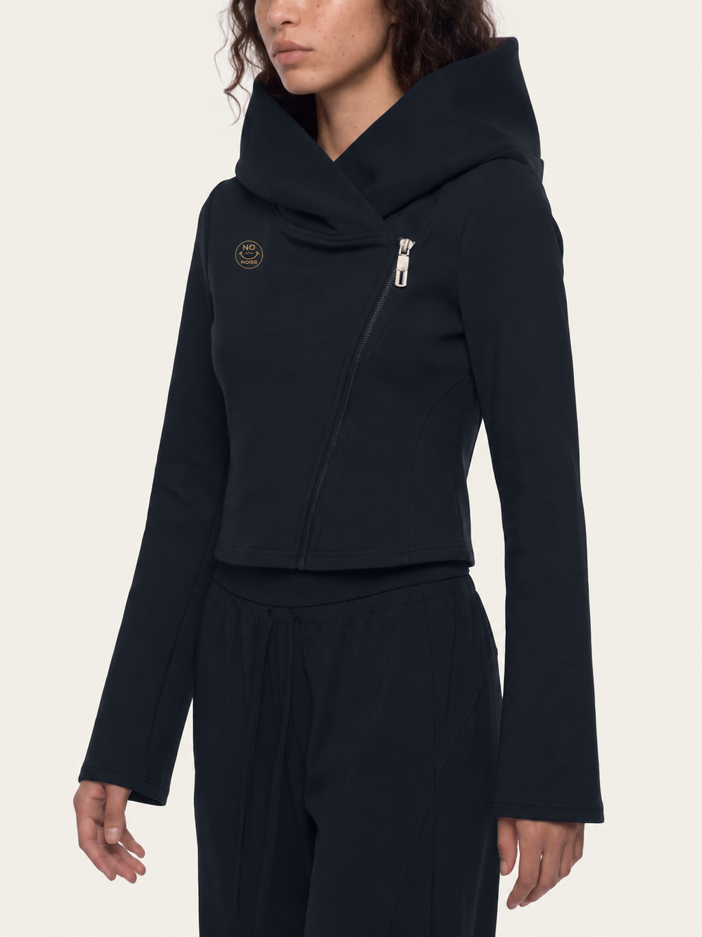Angled model mockup of the black Original Signal hoodie showing asymmetric zip, cowl hood and bell sleeves.