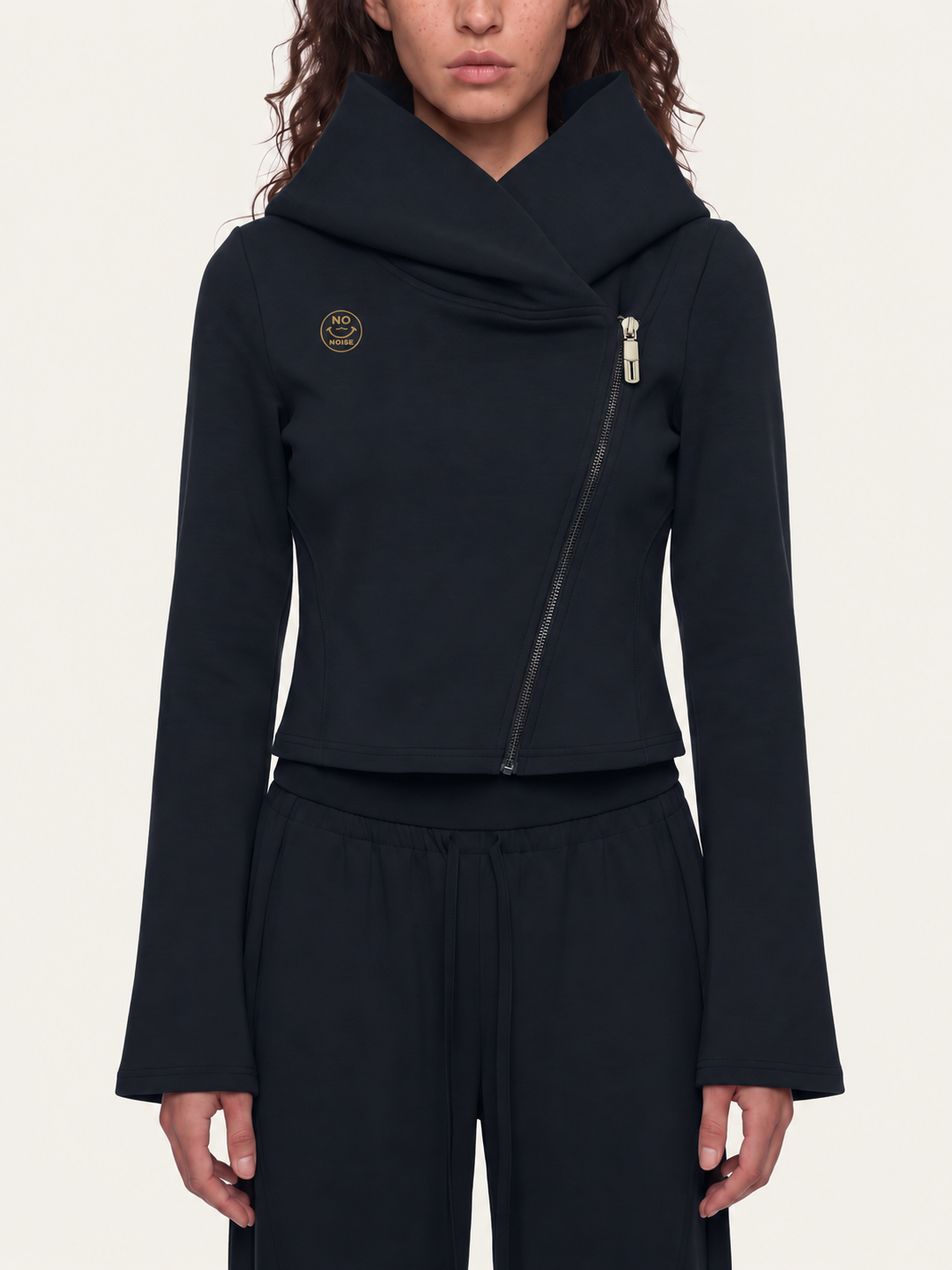 Front model mockup of the black Original Signal asymmetric hoodie with gold NO NOISE chest logo.