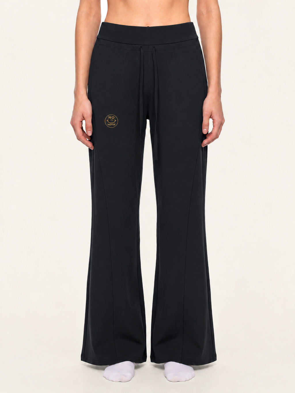 Front model mockup of black Original Signal flared sweatpants with gold NO NOISE thigh logo.