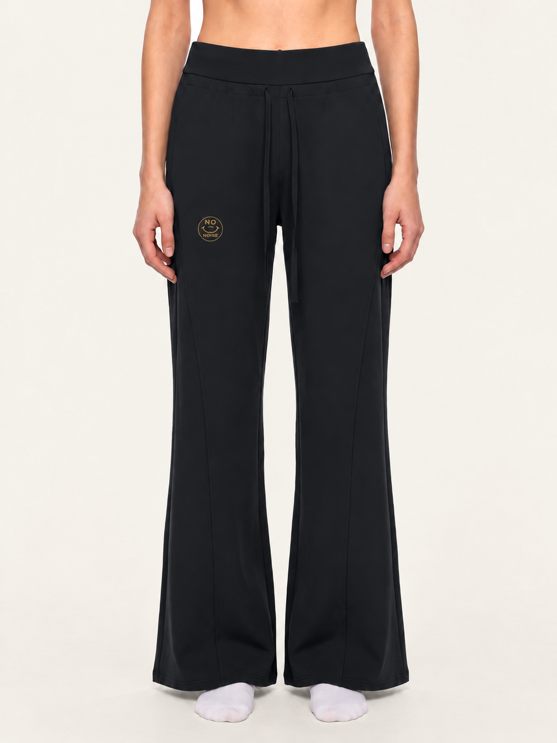 Front model mockup of black Original Signal flared sweatpants with gold NO NOISE thigh logo.