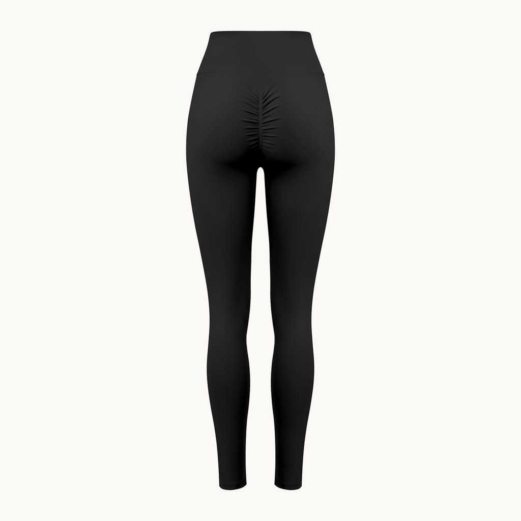 Poise High-Rise Leggings — Onyx, black, back shaped product view showing ruched seam. On warm ivory.